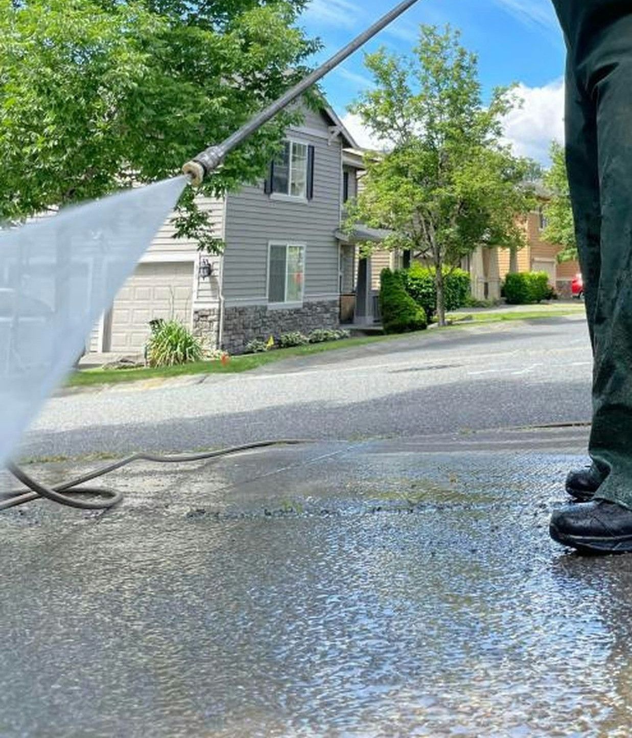 a man is cleaning the street with a hose