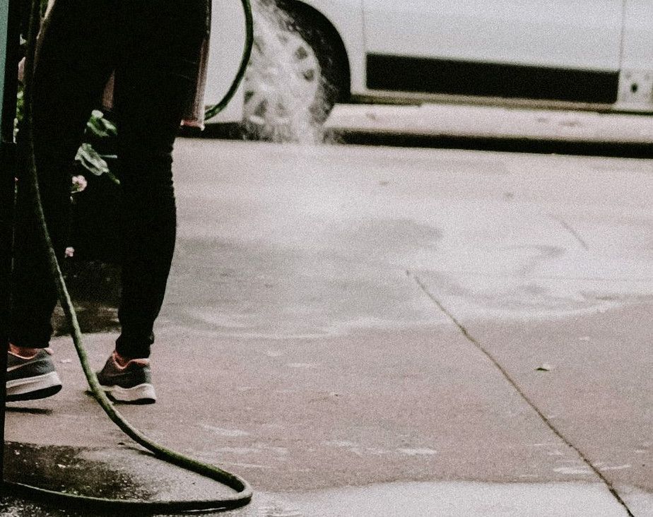 a man with a hose on a city street